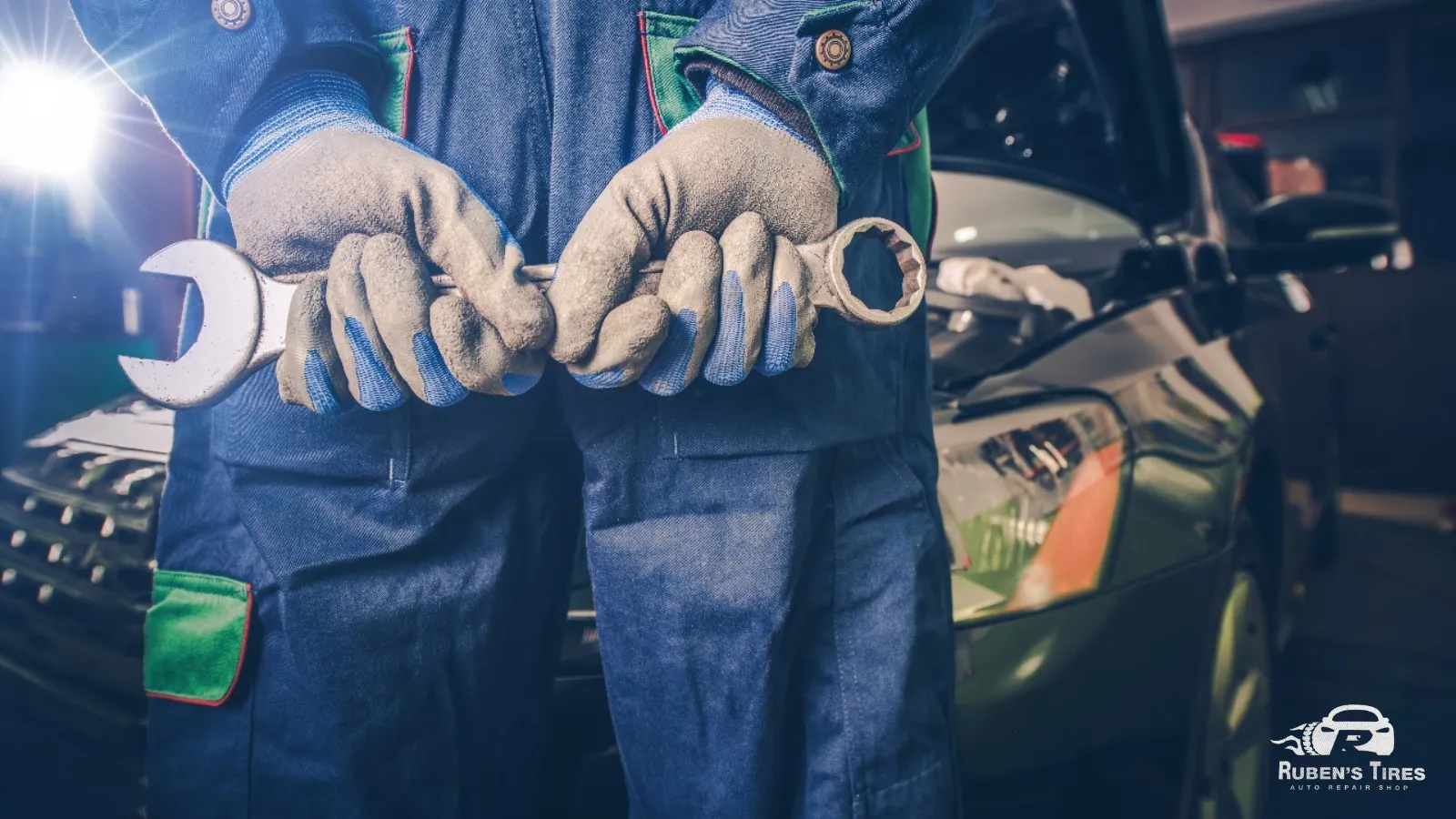 A mechanic holding a wrench in a workshop at Ruben’s Tires, representing skilled auto repair services in Altamonte.