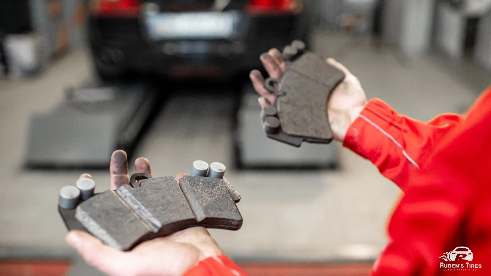 Mechanic holding worn brake pads, emphasizing the need for professional brake repair in Altamonte Springs.