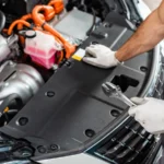 Technician in gloves performing maintenance under the hood of a modern vehicle, representing expert diagnostics and Engine Repair Altamonte Springs services.