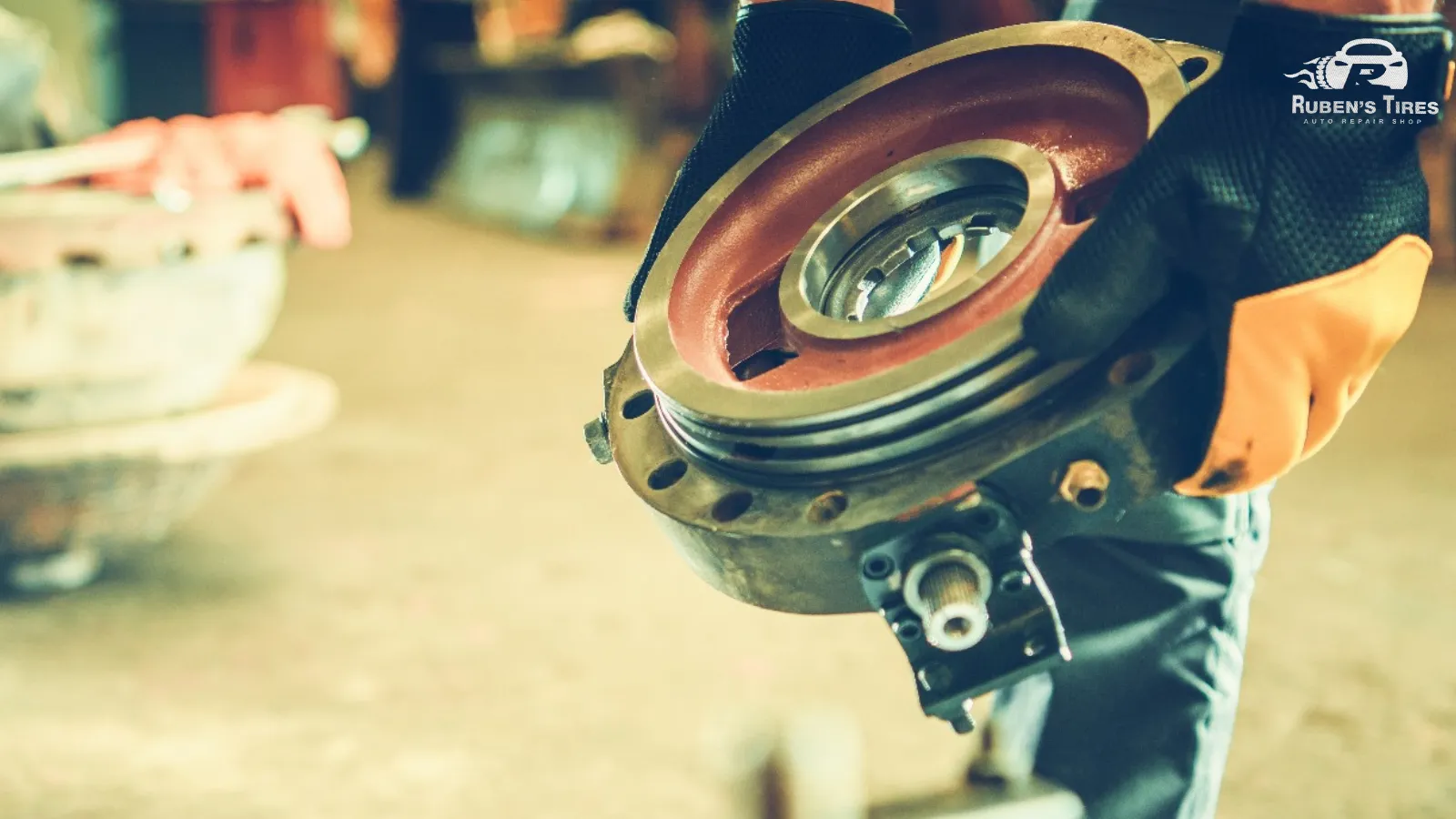 Technician holding a high-quality brake rotor at Ruben’s Tires in Altamonte Springs.