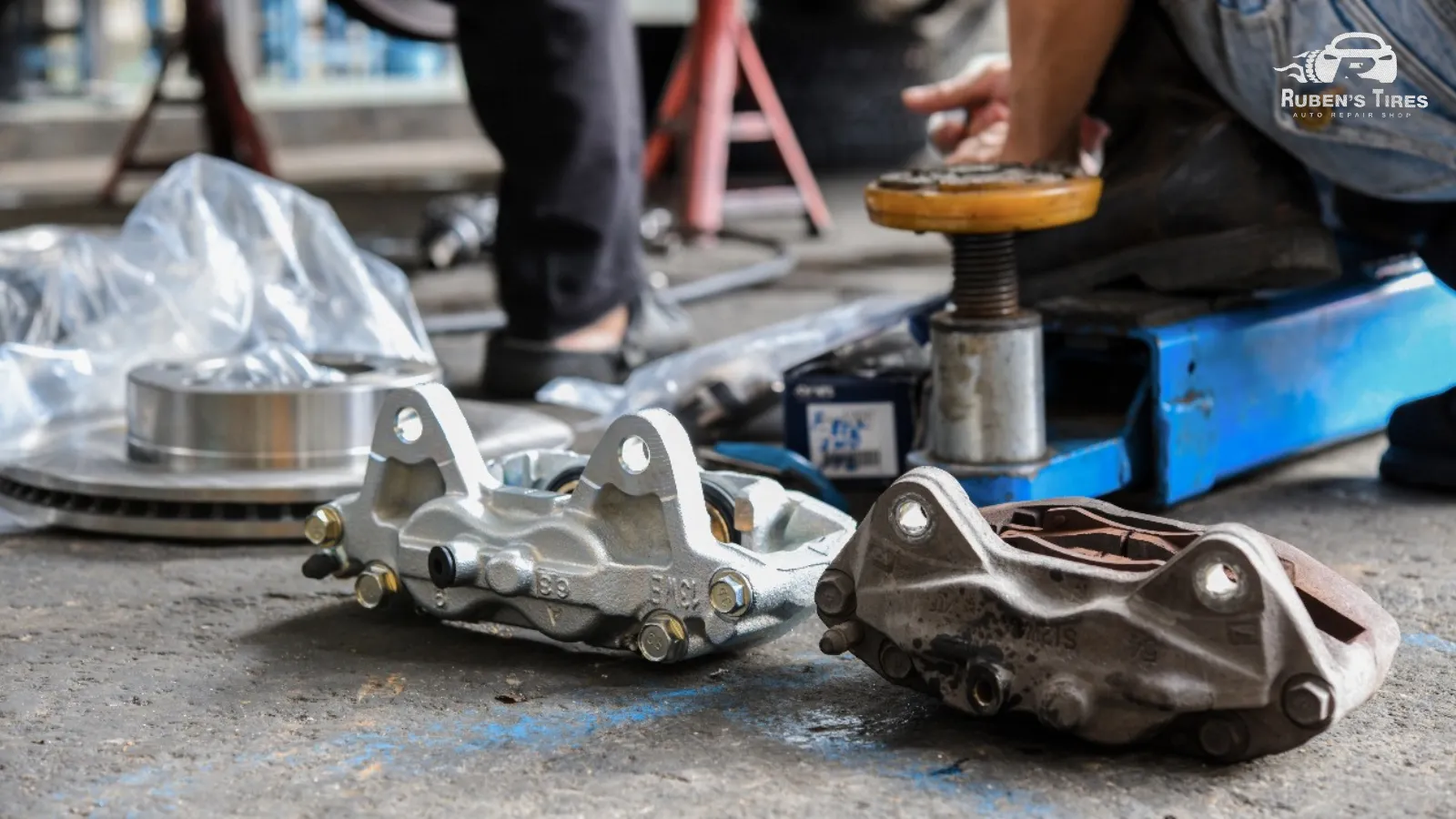 Brake calipers and rotors displayed in a repair shop, ready for installation.