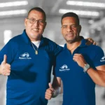 Two Ruben’s Tires team members smiling and giving thumbs up, representing the friendly and professional service emphasized in About Rubens Tires Altamonte.