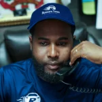 Ruben’s Tires customer service representative speaking on the phone, ready to assist with inquiries and support, highlighting Contact Rubens Tires Altamonte.